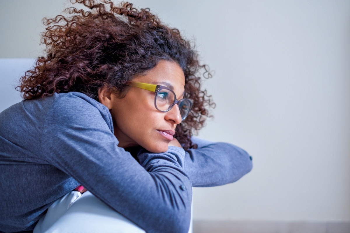 Worried woman at home alone