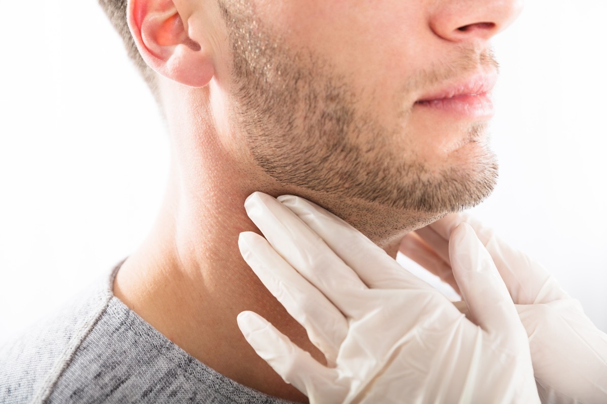 young white man having neck examined