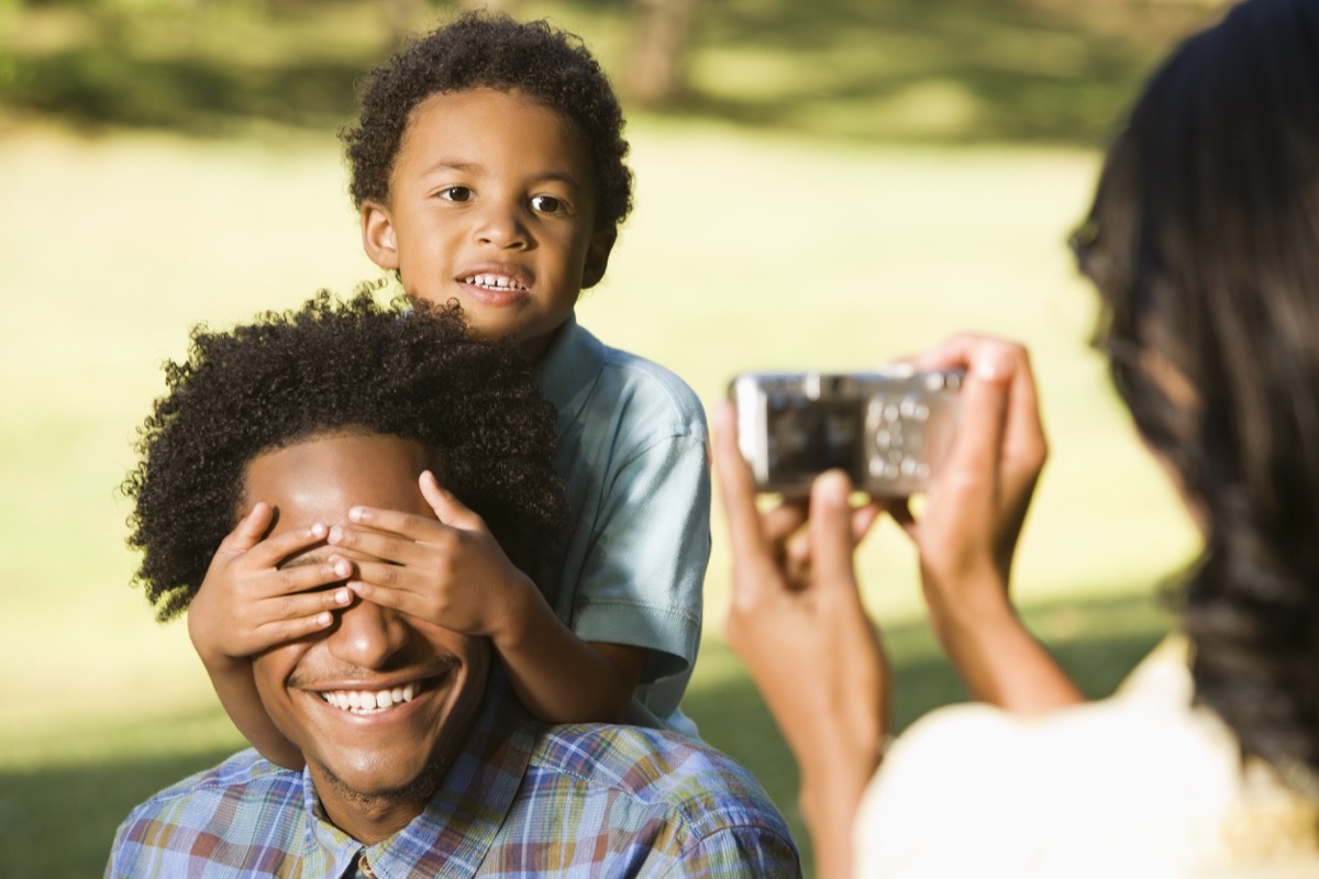 mom taking pictures of son and dad