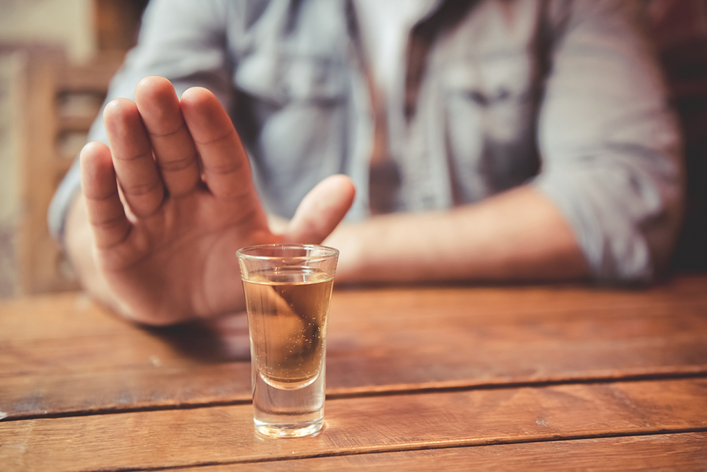 man refusing alcohol shot 