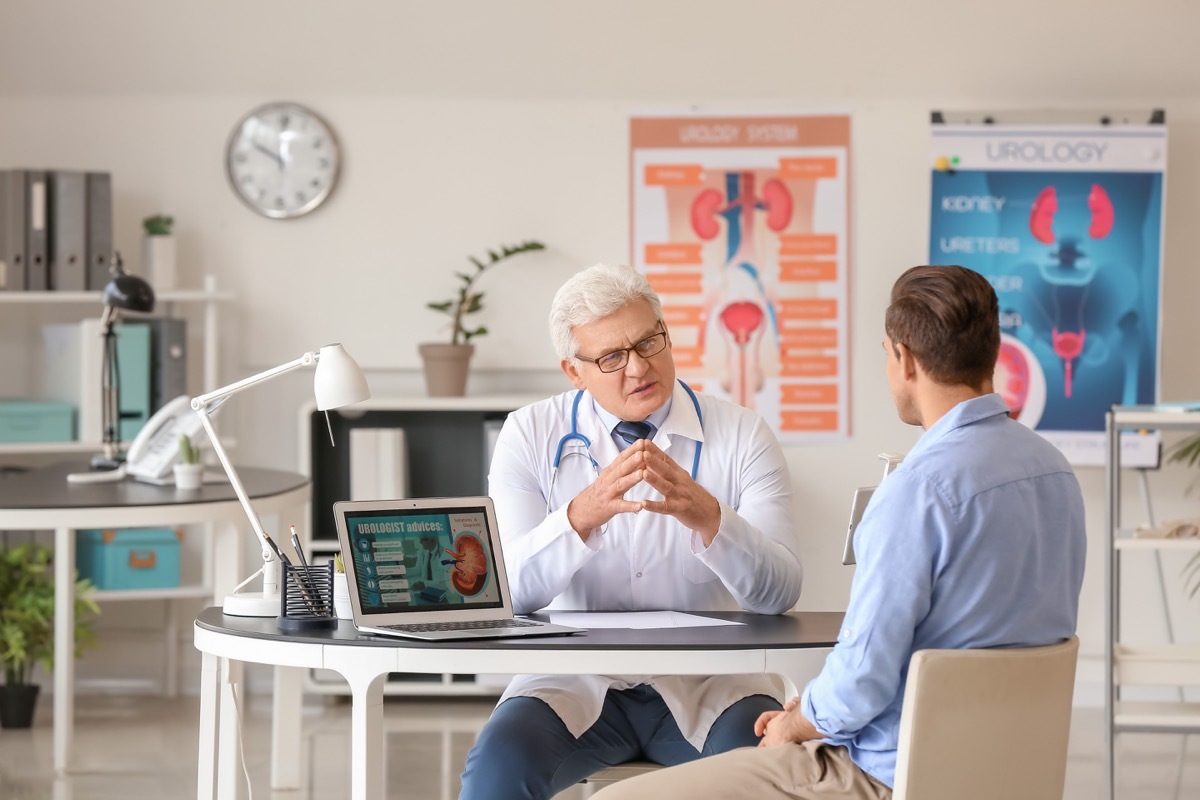 Young man visiting urologist in clinic, kidney doctor