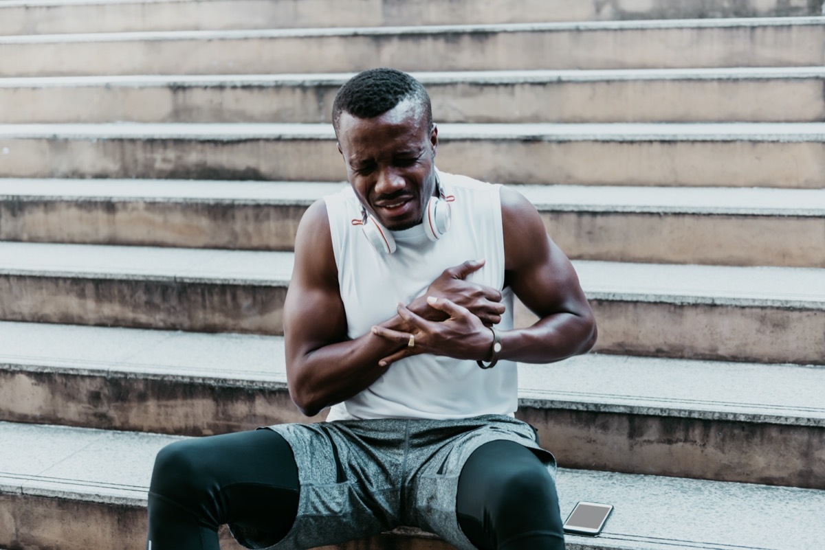 Athlete man having pain in the chest due to heart disease.