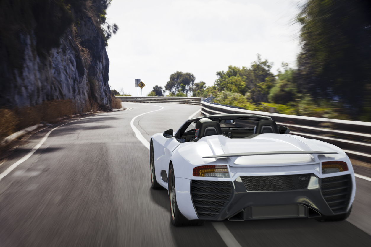 white coupe on the open road