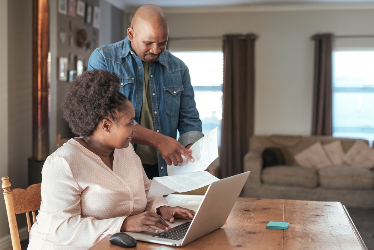 middle-aged black couple paying bills