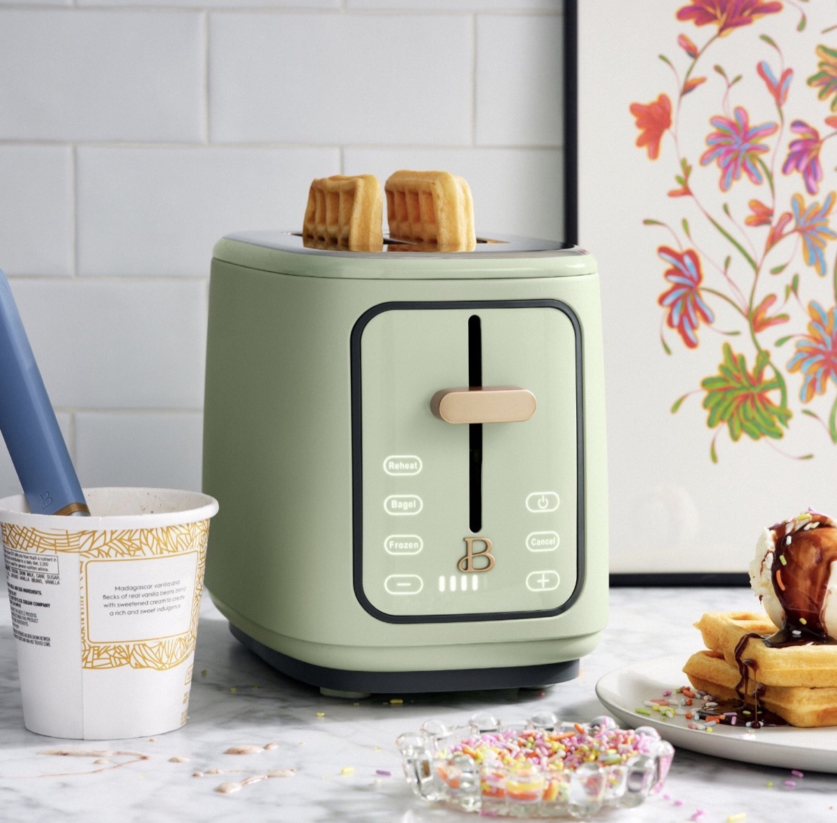 sage green toaster with waffles in it