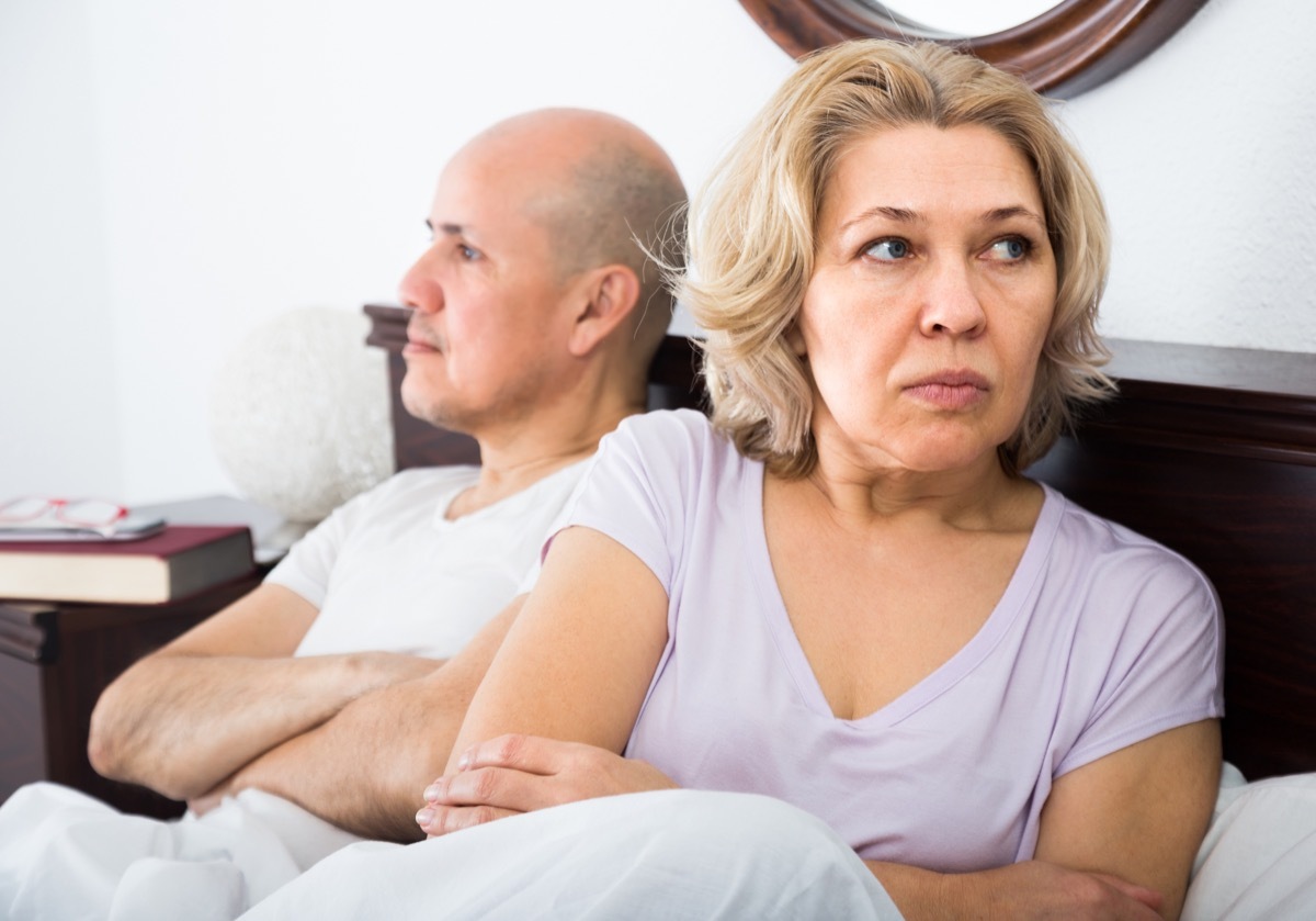 older couple fighting in bed, worst things about being an empty nester