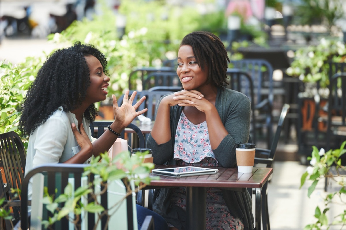 women talking in an outdoor courtyard Canadian Traditions