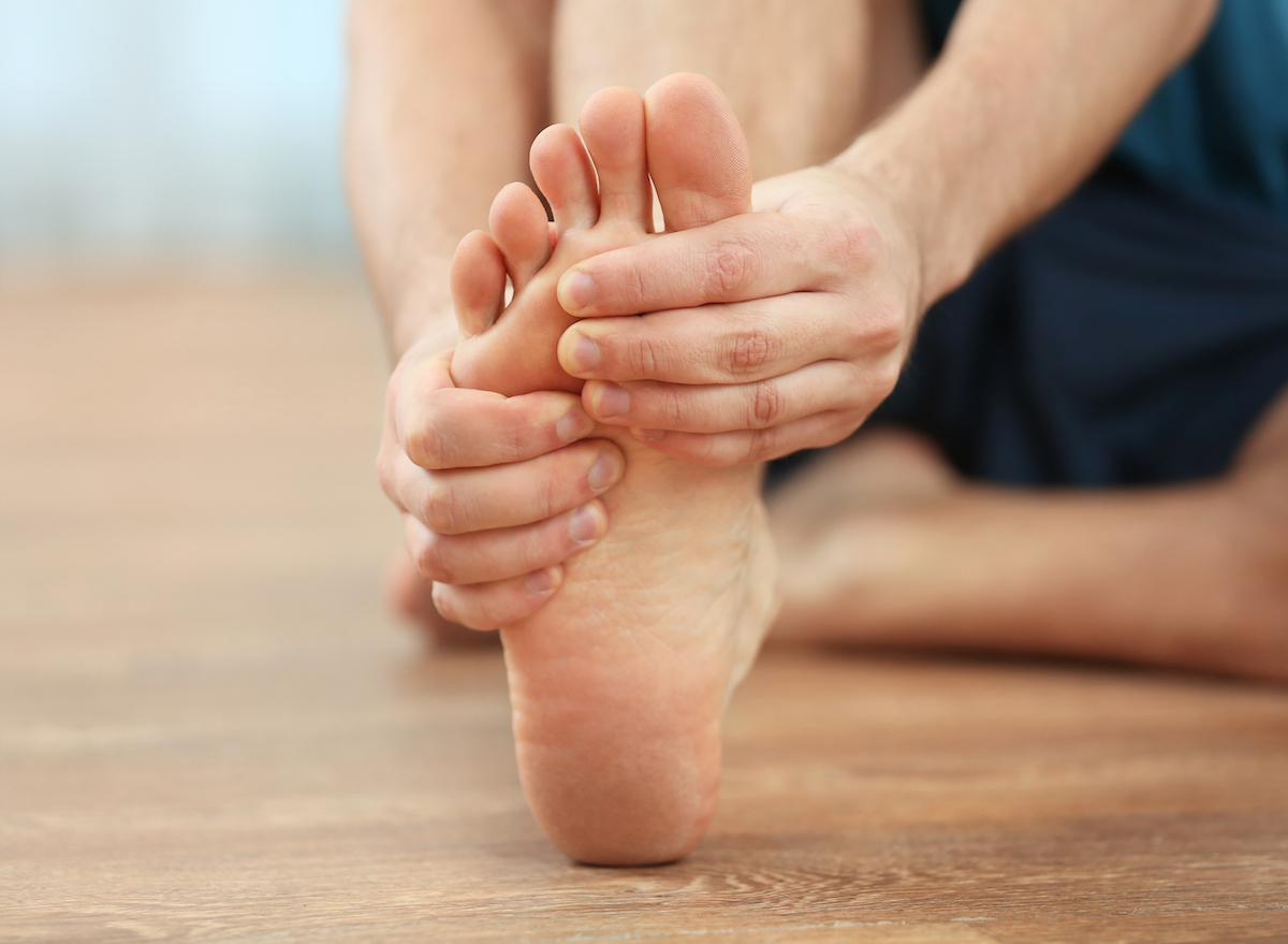 man-holding-injured-foot-stretch