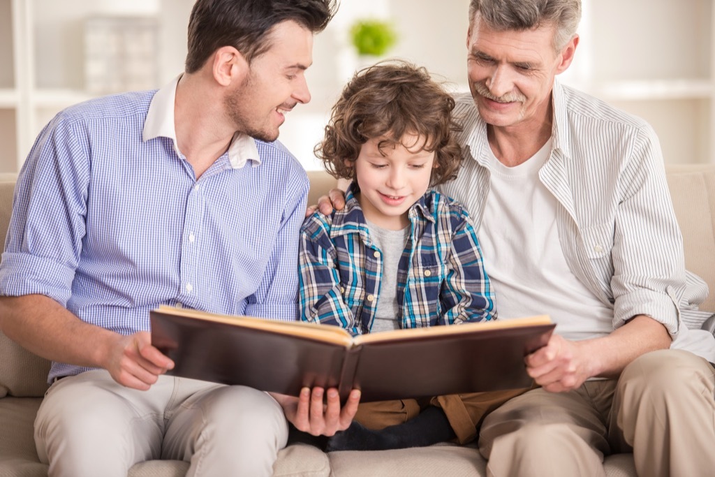 dad son and grandfather reading book