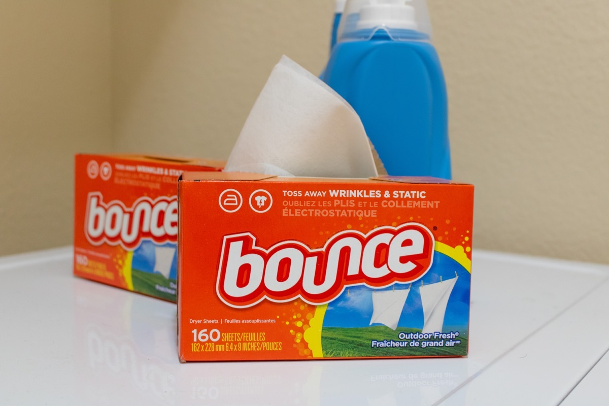 two boxes of bounce dryer sheets next to laundry detergent