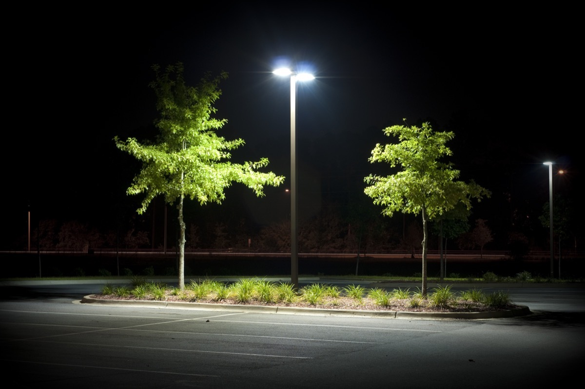 empty parking with one light pole at night