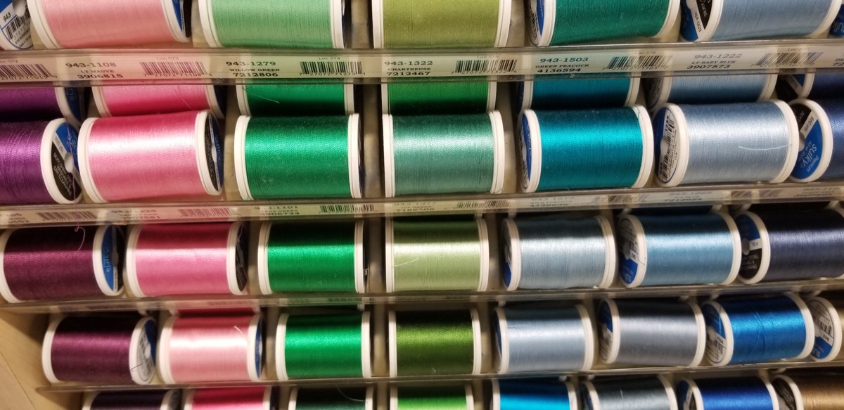 row of thread on spools