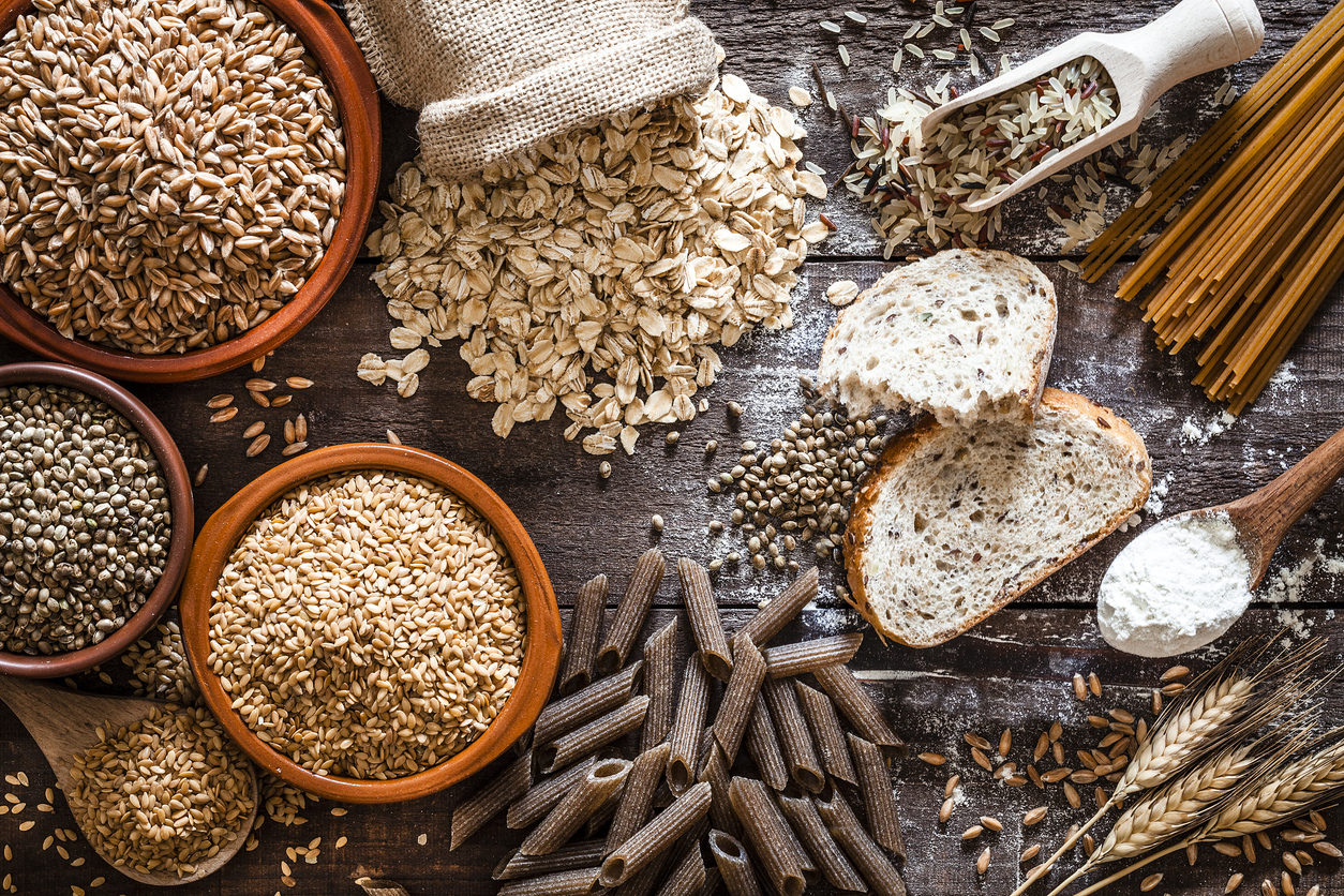 A splay of seeds, grains, and products like bread and pasta