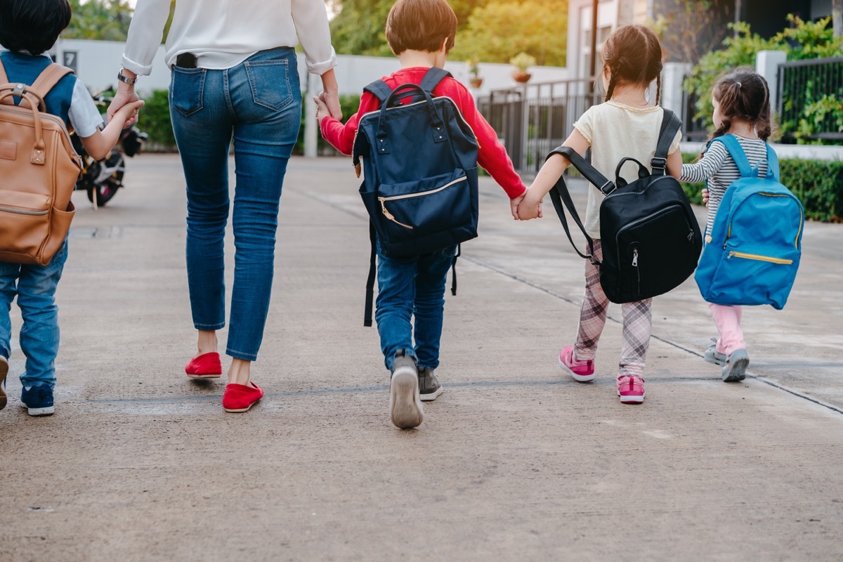 Woman walking kids to school