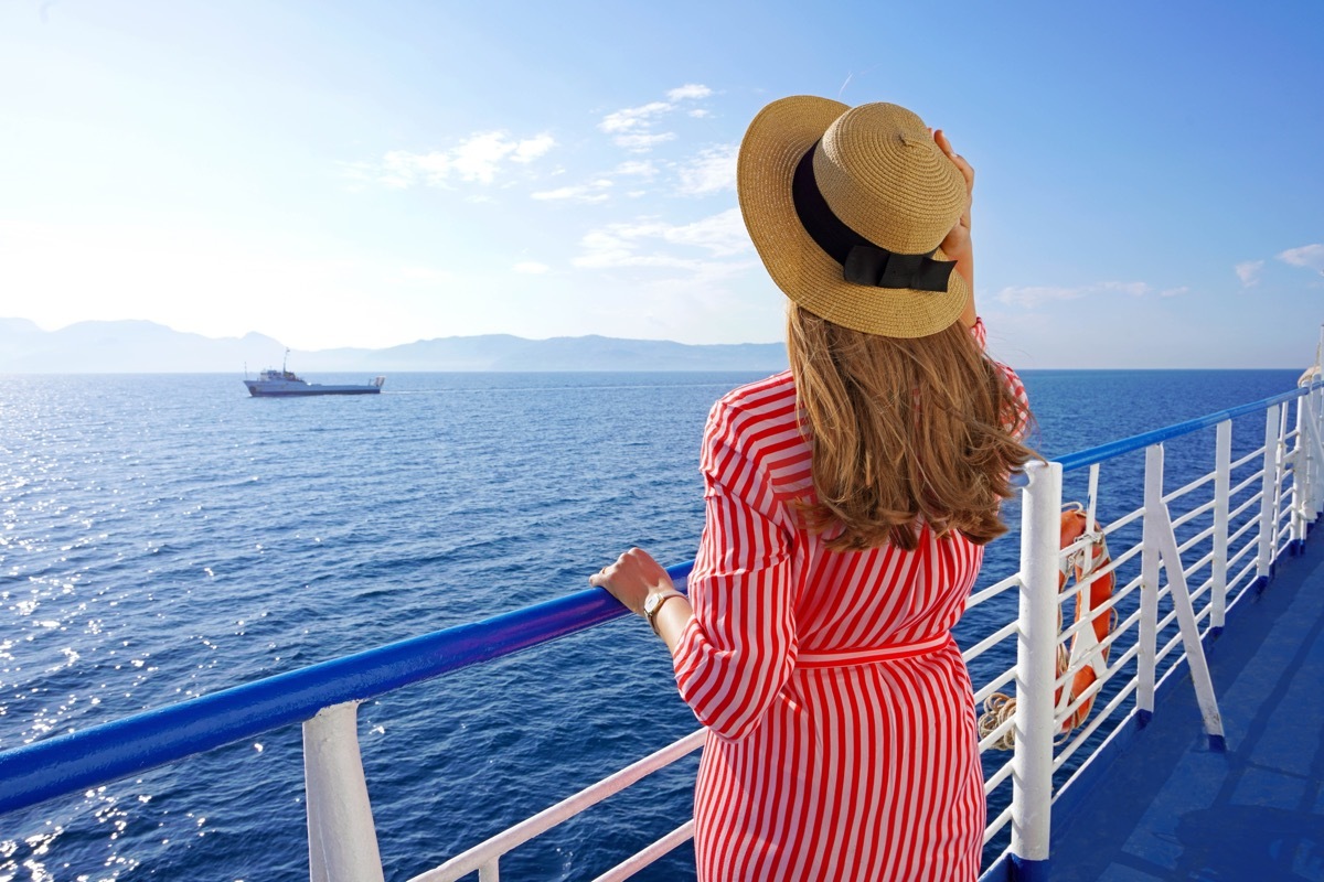 Cruise ship vacation holiday. Back view of relaxed fashion woman enjoying travel on cruise liner.