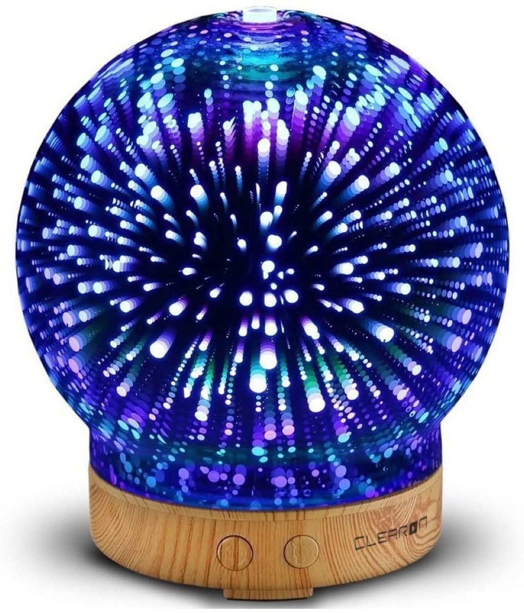 blue glass orb essential oil diffuser on wooden base