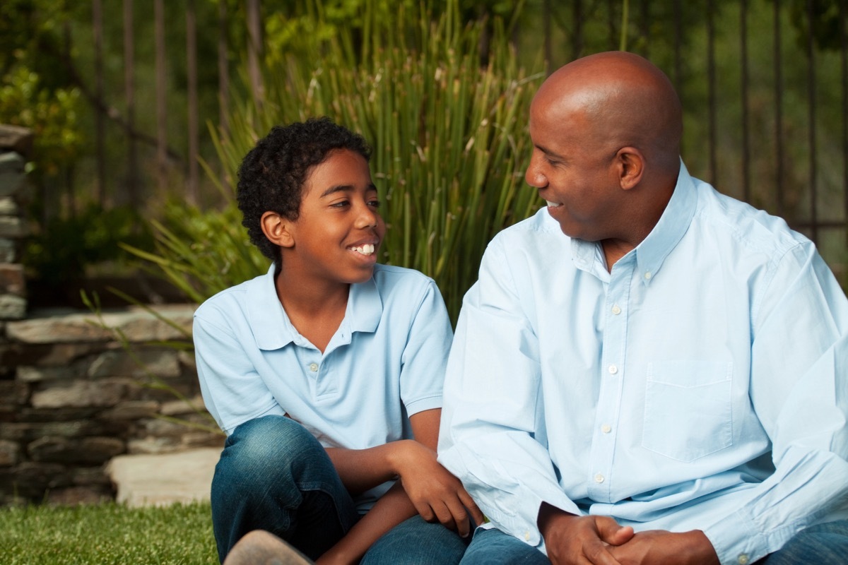 Black father and son talking