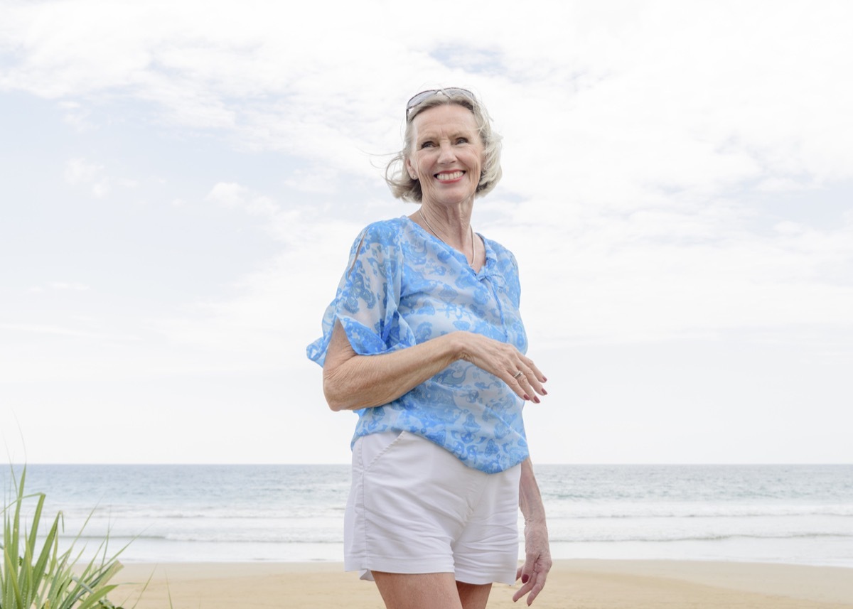 older woman wearing shorts at the beach