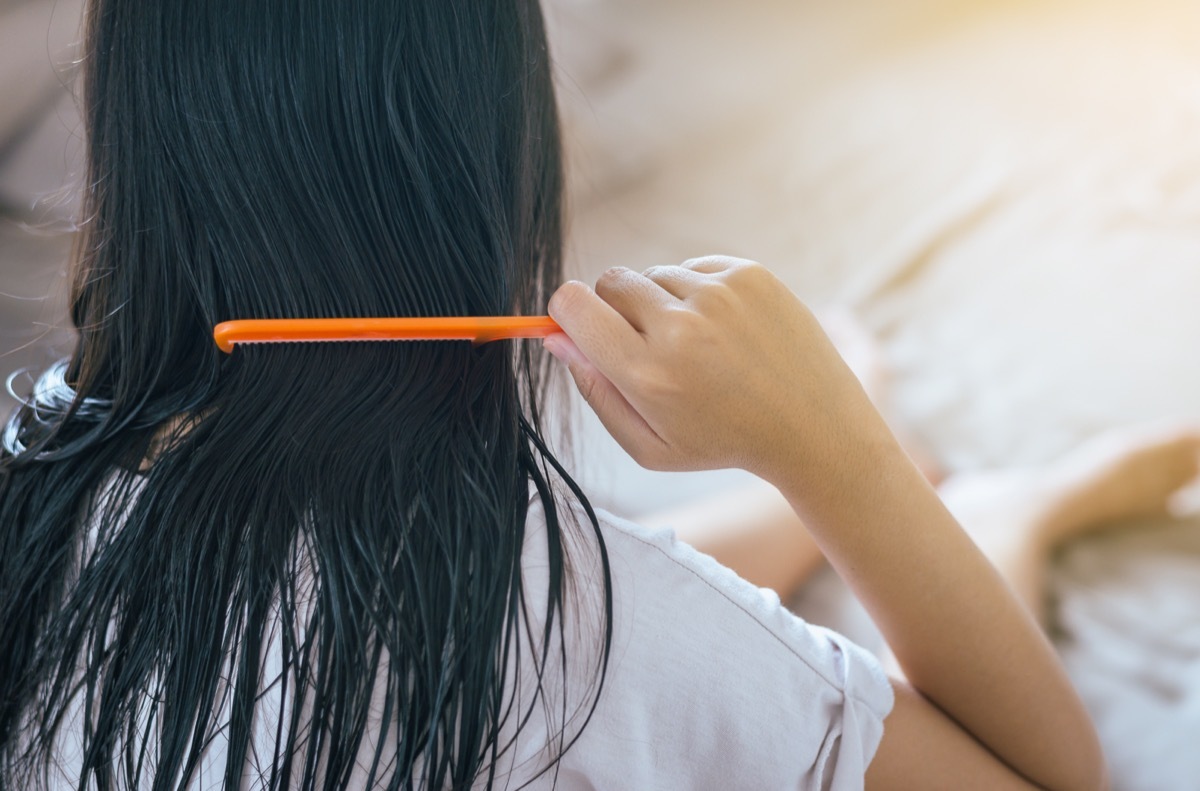 young woman combing wet hair