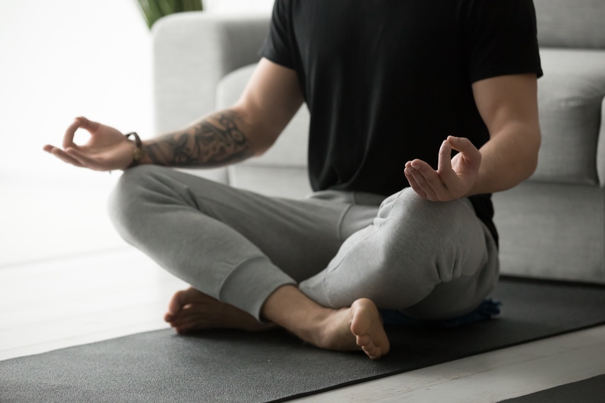 Man meditating on mat