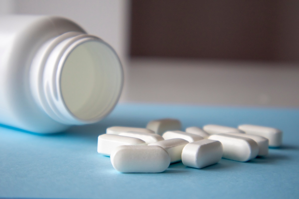 Magnesium Vitamins And Jar On a Blue Background. Blank space for the inscription on the tablet