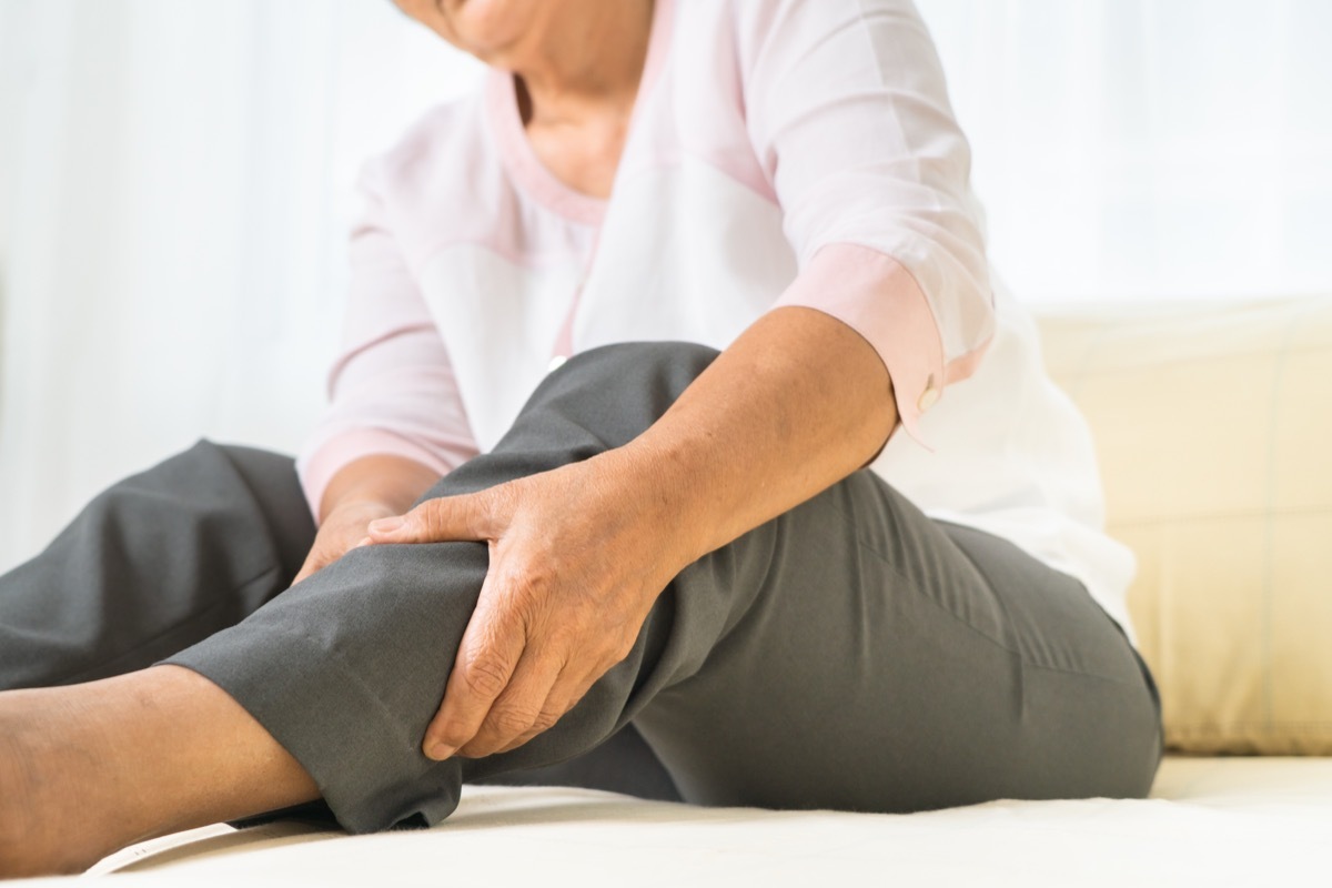 woman holding her leg in pain