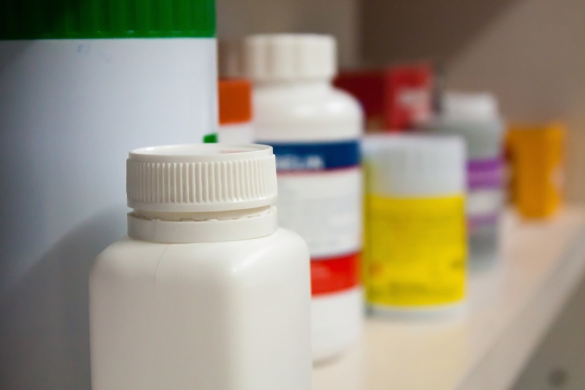 open medicine cabinet full of prescription bottles