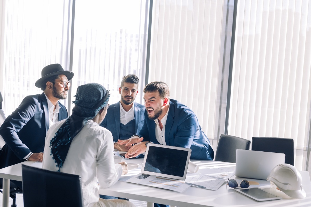 coworkers in an office firing good comebacks at one another during a disagreement