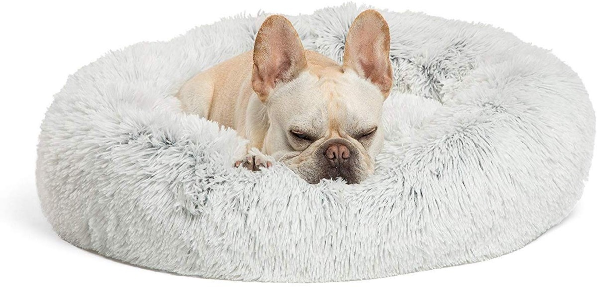 French bulldog sleeping on plush fur bed