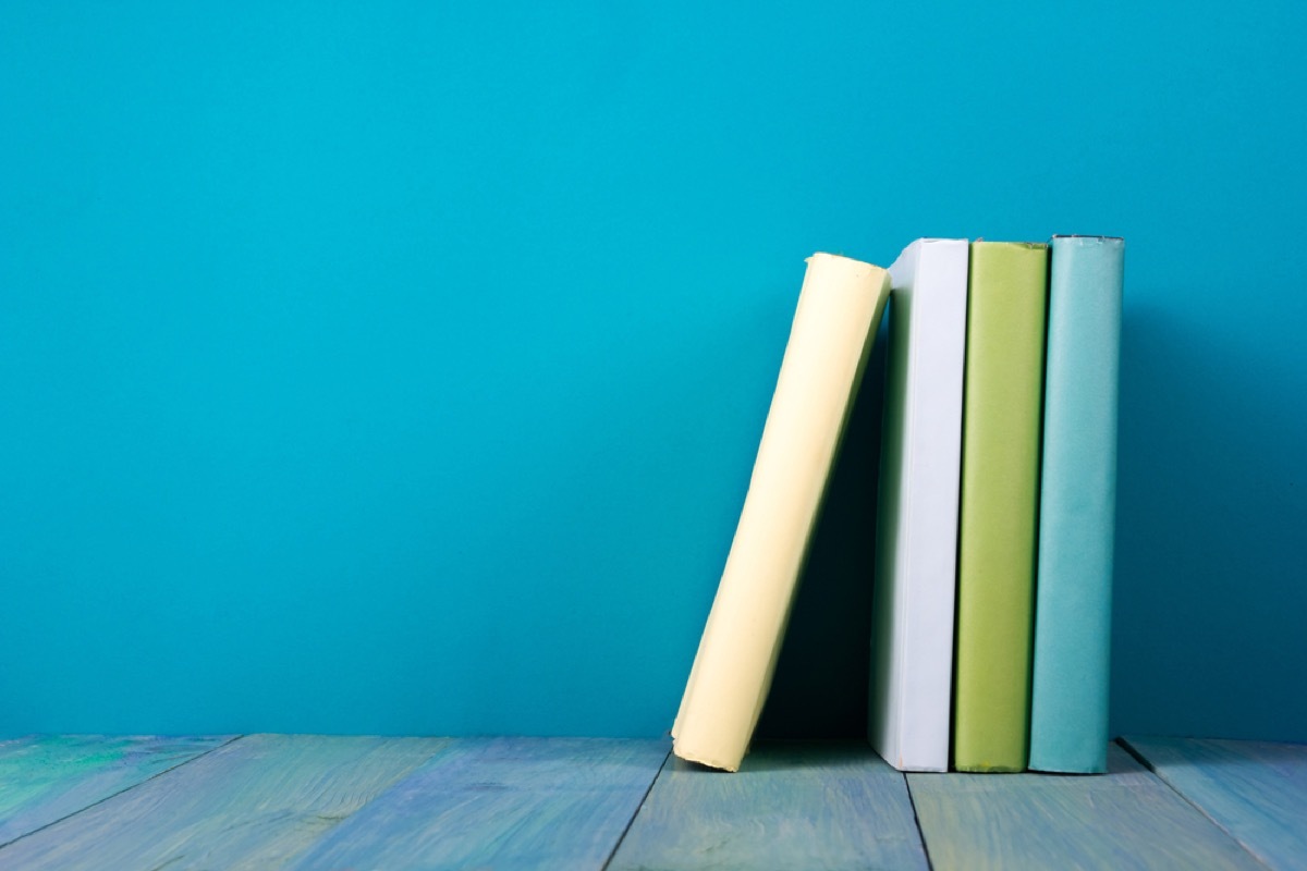 set of green books against blue background