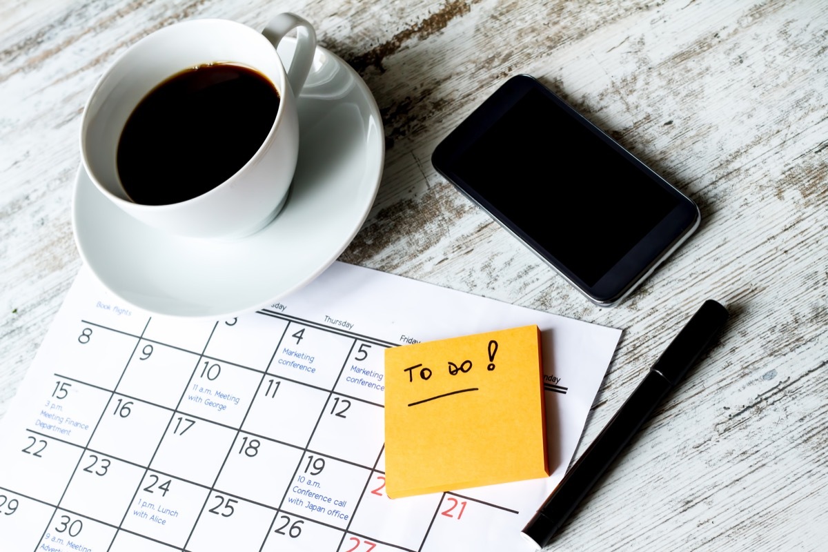 to do list on table with post it coffee and phone