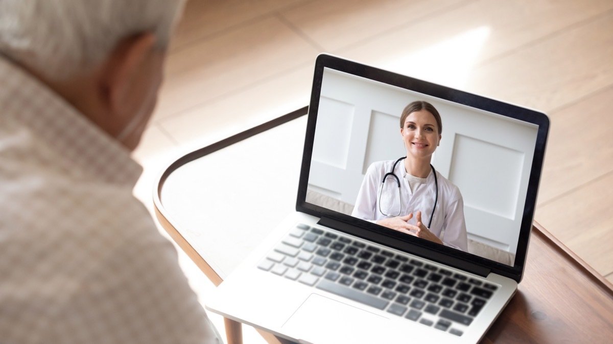 older man on video call with doctor