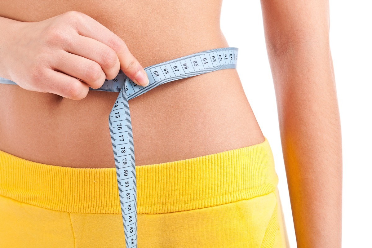 woman measuring stomach, beauty pageants