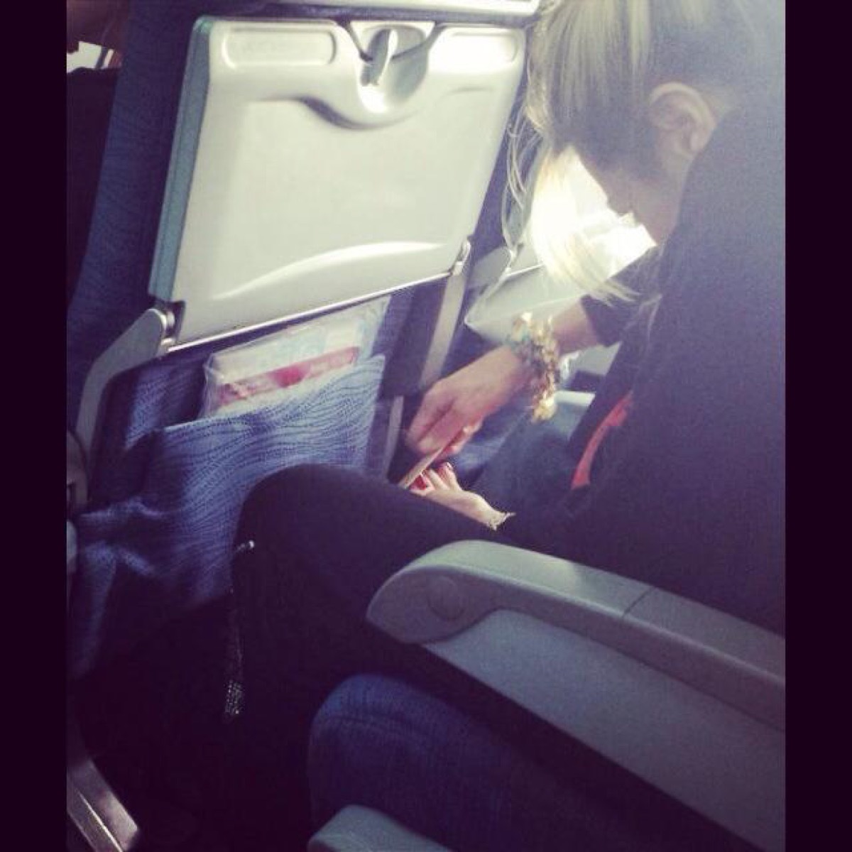 Woman filing toenails on an airplane photos of terrible airplane passengers