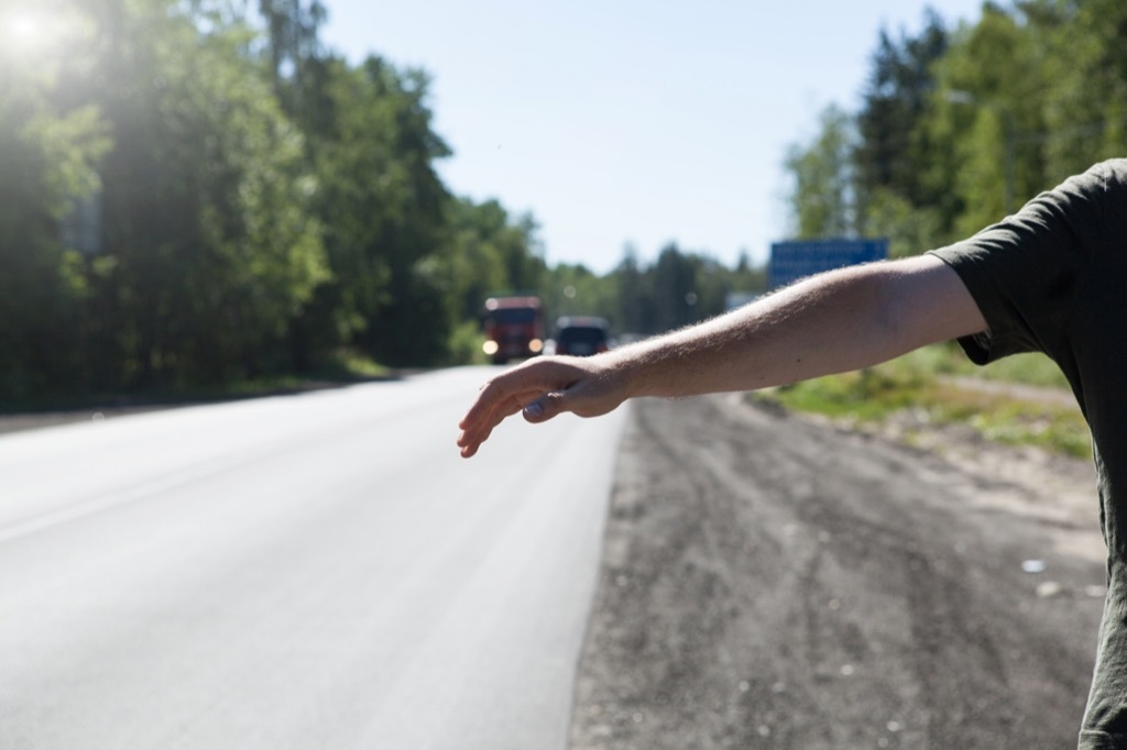 Man holding out his hand to hitchhike