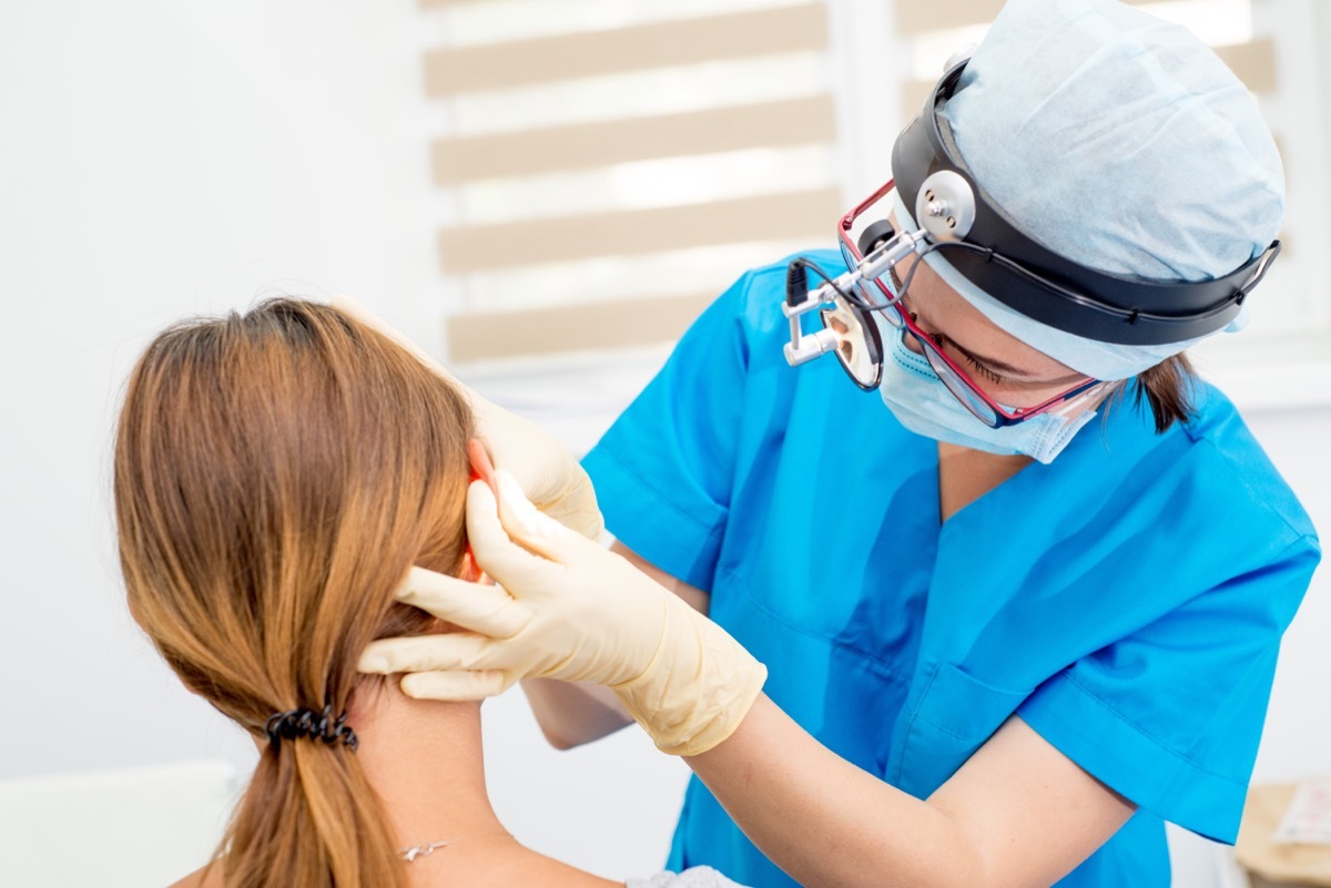 ear, nose, and throat doctor looking at a patient's ear