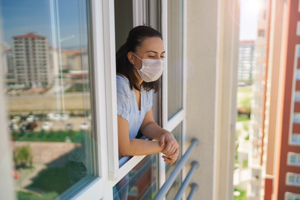 Sad woman looking through the window