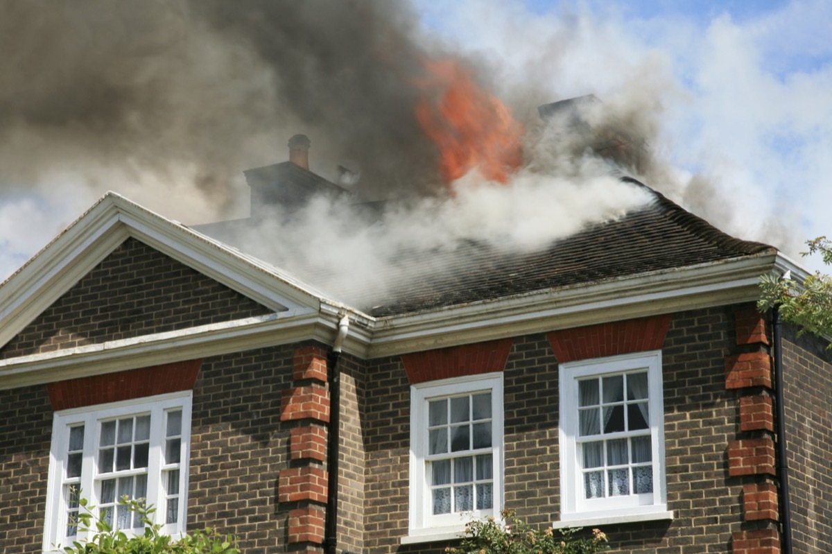 house with roof on fire