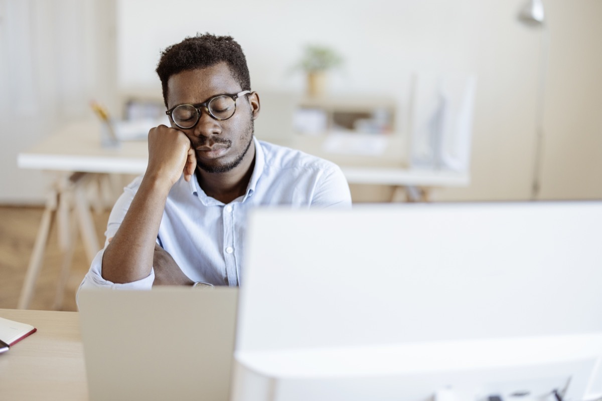 Tired overworked businessman sleeping at job in his office