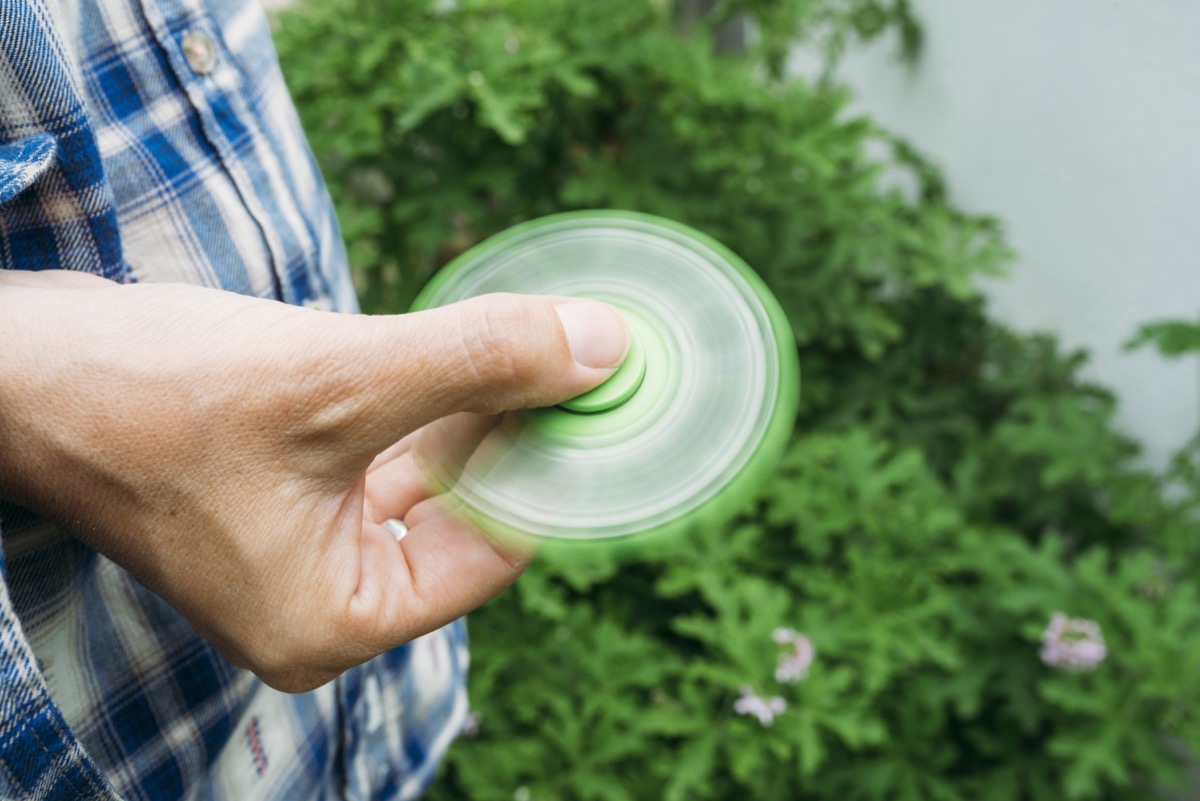 man holding fidget spinner