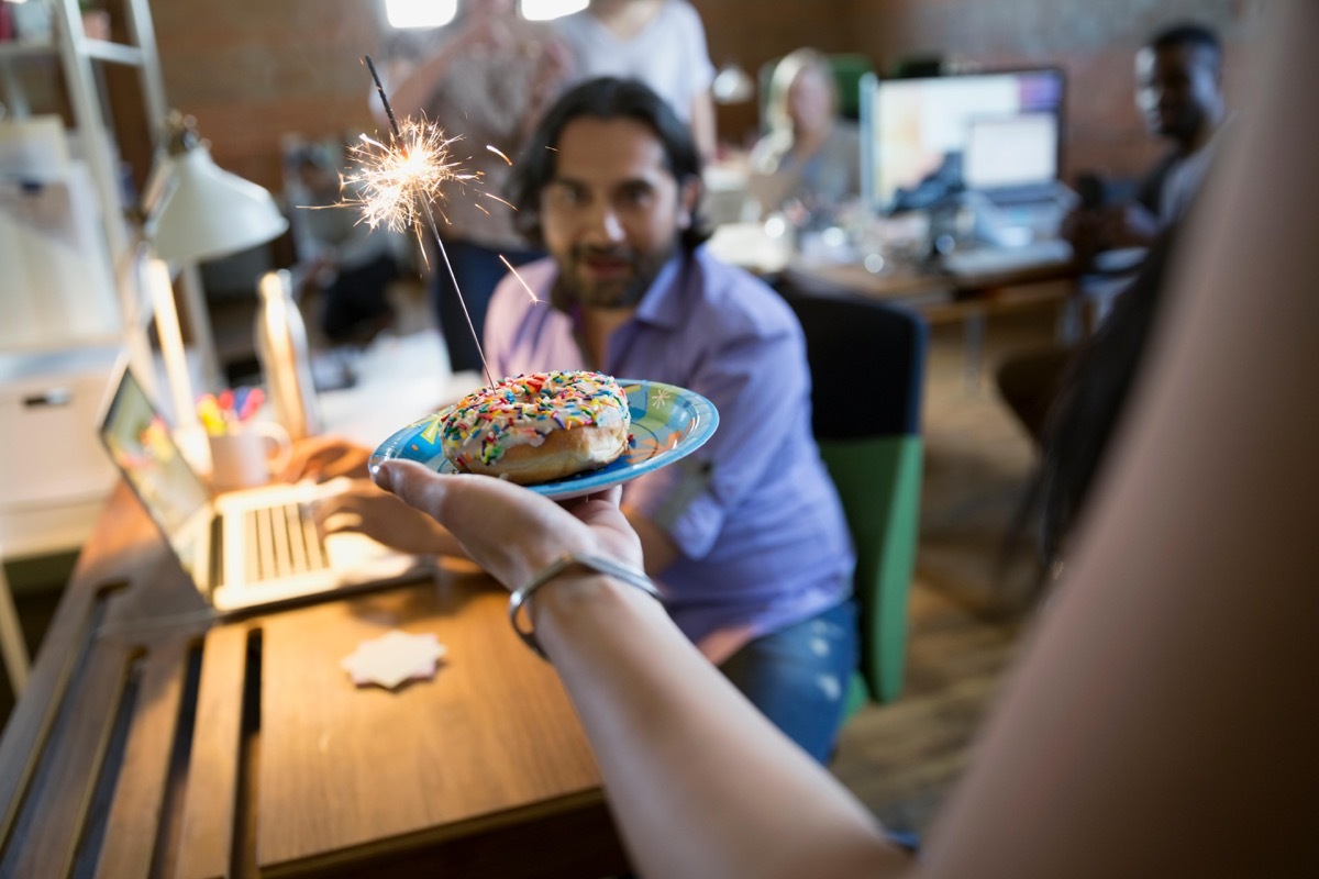 Coworker being kind and giving colleague a birthday donut