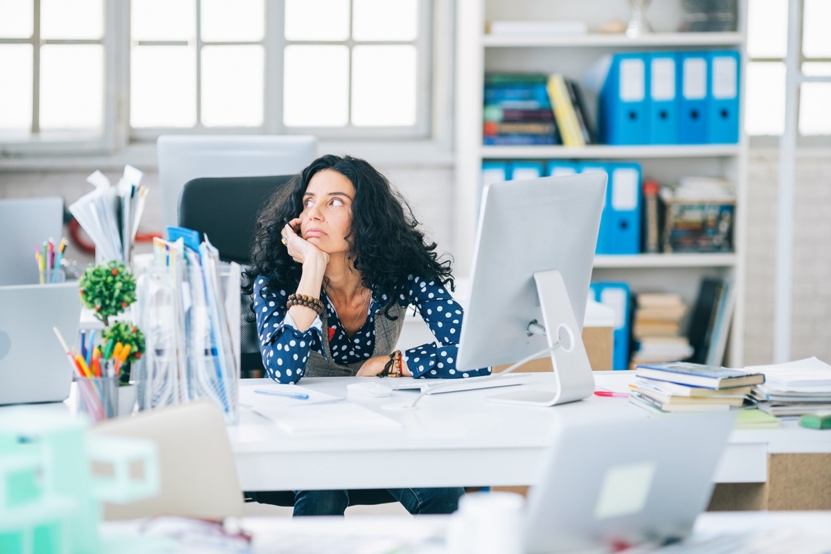 Woman distracted in her office.