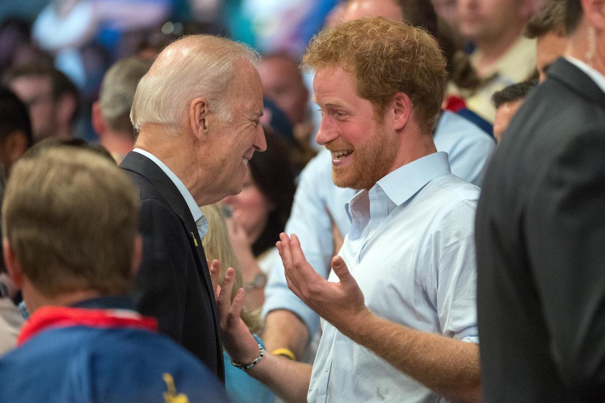 Prince Harry of Wales and Vice President Joe Biden bump into each other in the stands of a wheelchair rugby match during the 2016 Invictus Games at the ESPN Wide World of Sports Complex May 11, 2016 in Orlando, Florida