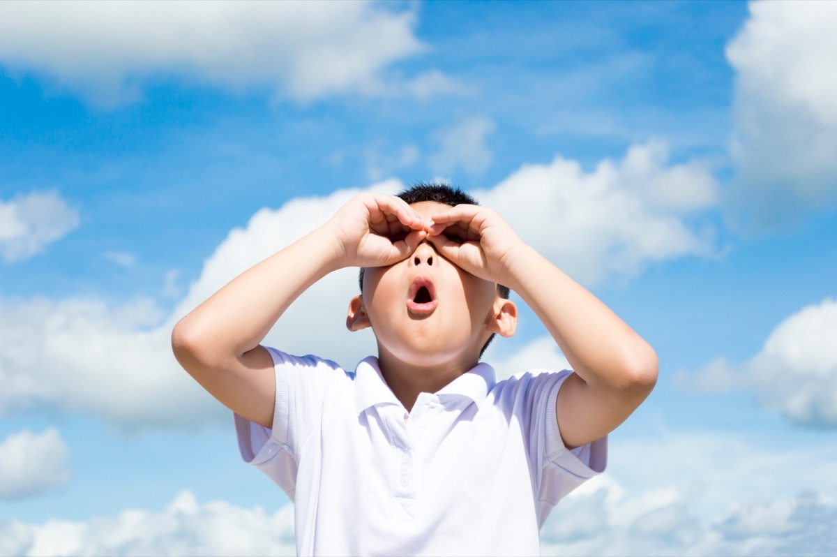 little boy looking up at the sky