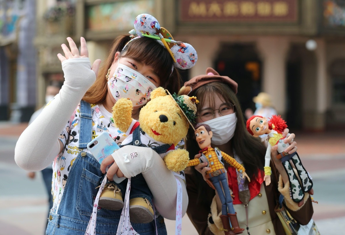 two young girls pose for a photo at shanghai disneyland