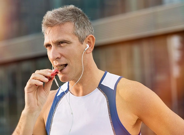 Man eating protein bar