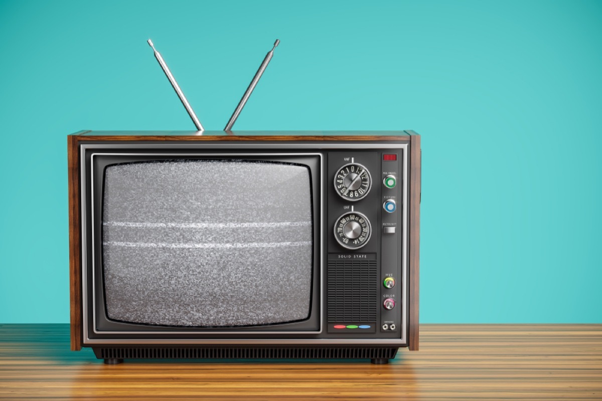 old tv with antennae and blue background