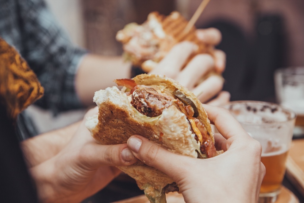 woman eating a bacon cheeseburger