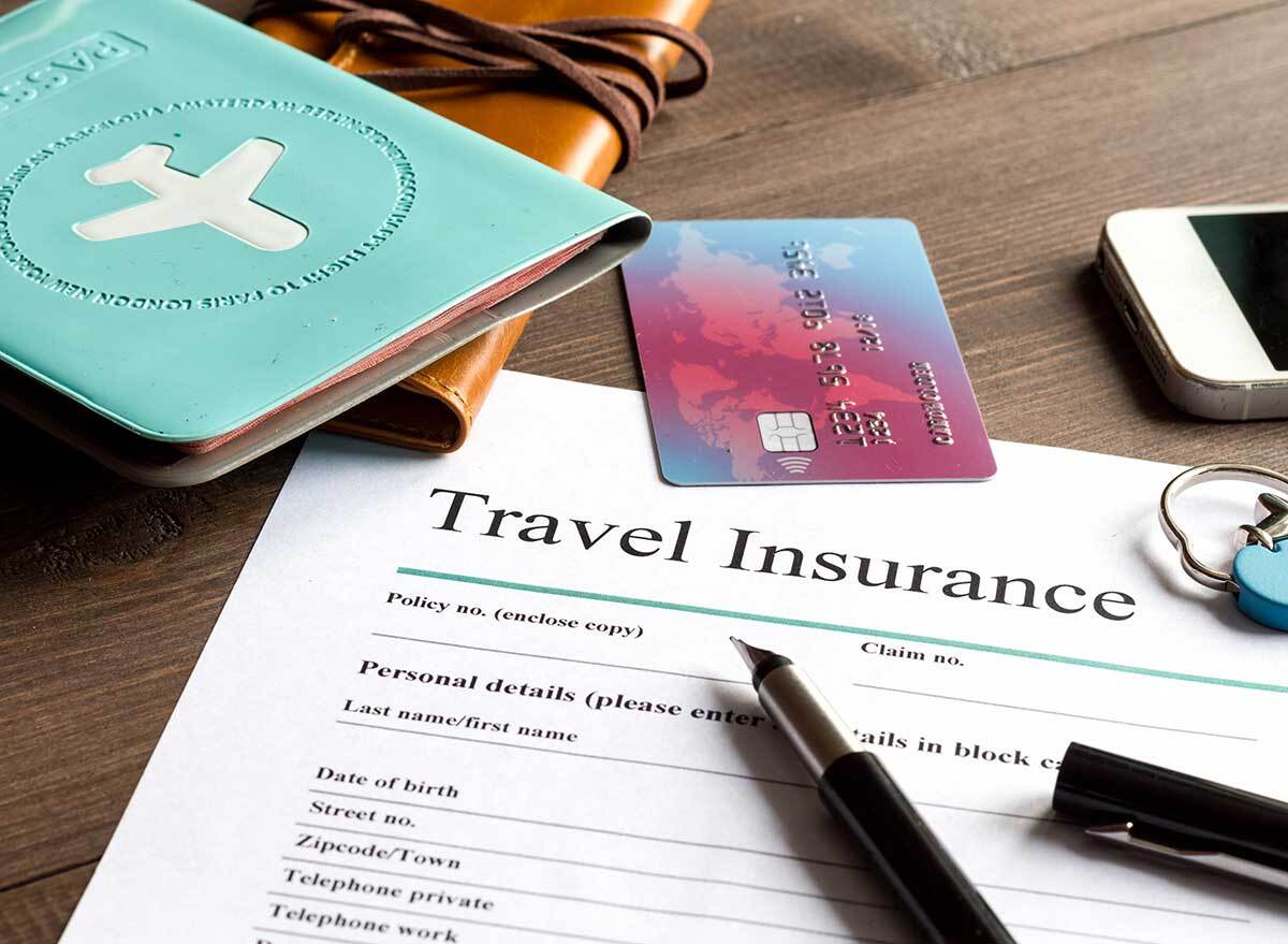 travel insurance papers, credit card, and passport document