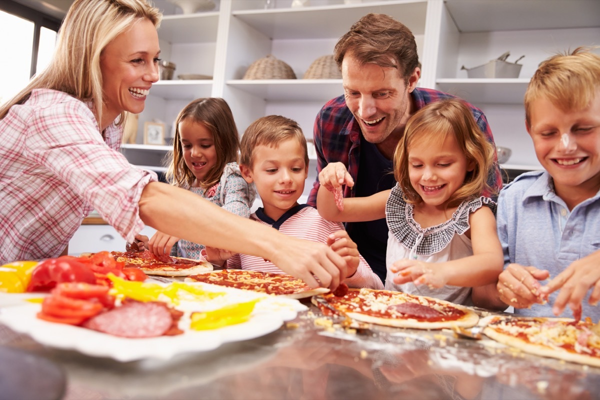 Family making a homemade pizza